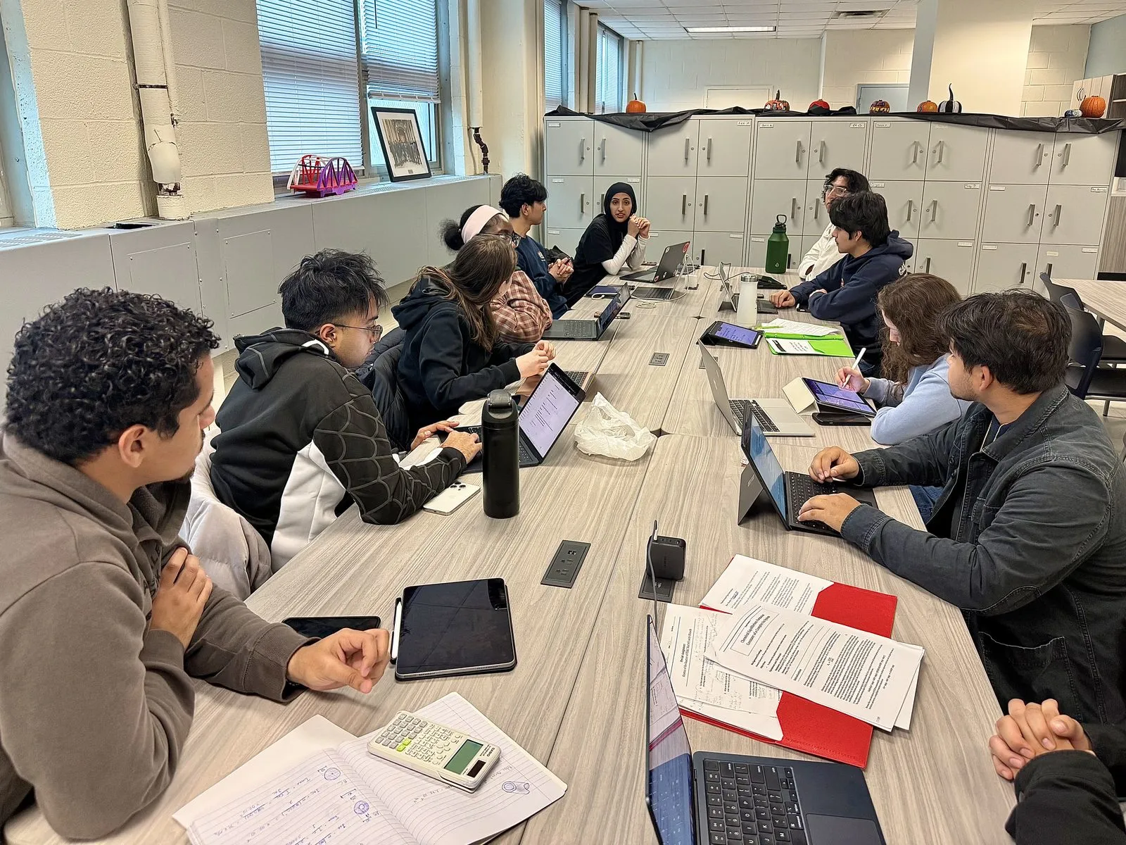 EWB-CCNY members around a table during a fundraising meeting