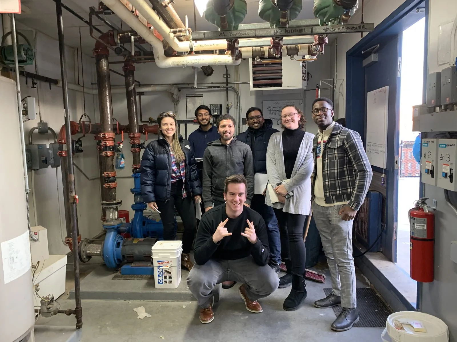 EWB-CCNY members and staff in the building's boiler room during the energy assessment