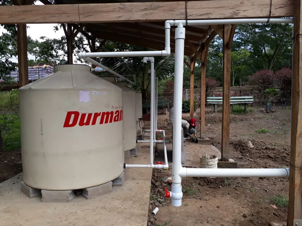 A water catchment tank installed on a raised timber frame in Tadazna, Nicaragua